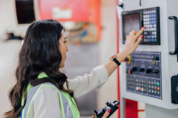 Female operator programming a CNC machine