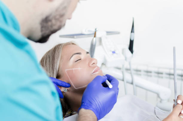 Female patient preparing for botox A male doctor works on tightening face to his patient. It uses the latest generation botox. human jaw bone stock pictures, royalty-free photos & images
