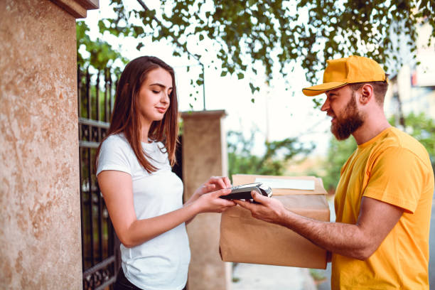 female-paying-delivery-man-with-credit-card-and-entering-code