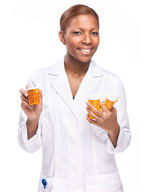 Female Pharmasist with Medicine Bottles stock photo