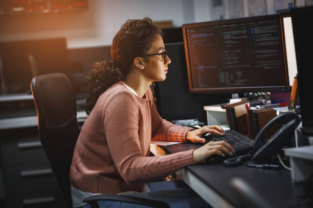 Female programmer working on new project. Female programmer working on new project.She working late at night in her office. developer stock pictures, royalty-free photos & images