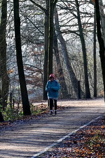 Moenchengladbach, Germany, January 10, 2022 - Unidentified woman jogging in Rheydt castle park