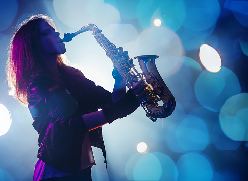 Female Saxophone Player Stock Photo - Download Image Now - iStock