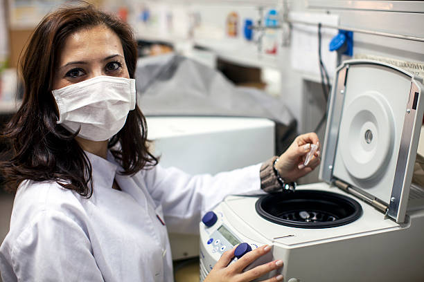 female scientist using centrifuge 2 stock photo