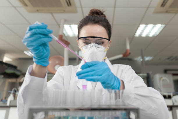 Female scientist working in the CDC laboratory. Female scientist working in the CDC laboratory. genetic research stock pictures, royalty-free photos & images
