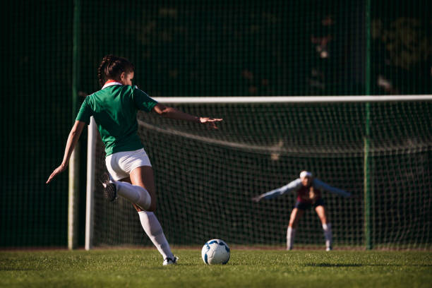 Female soccer players - penalty shot stock photo