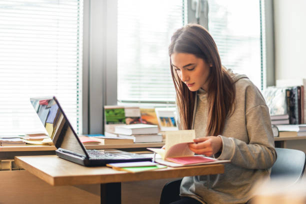 Female student learning in library stock photo