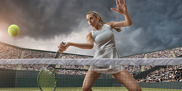 female tennis player about to strike ball - wimbledon tennis stok fotoğraflar ve resimler