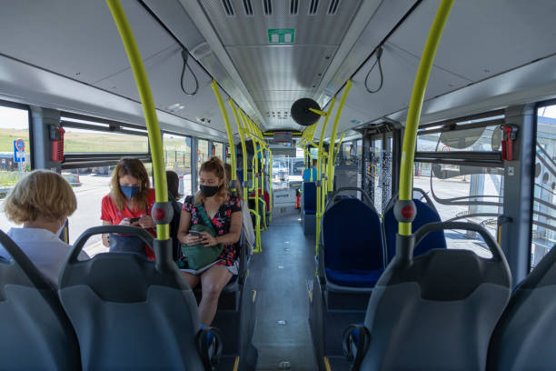 Female travelers sitting on a bus, Segovia, Spain Segovia, Spain - June 2, 2021: Female travelers sitting on one of the buses of the line 11 Acueducto, leaving the Segovia Guiomar train station public service stock pictures, royalty-free photos & images