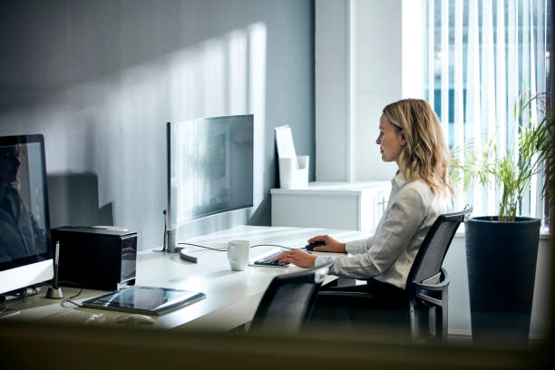 Female using computer in office stock photo