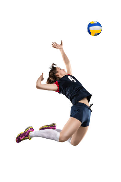 Female volleyball player hitting the ball Female volleyball player in the air before hitting the ball isolated on white background spiked stock pictures, royalty-free photos & images
