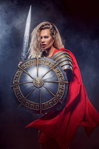 A female Warrior Gladiator holding a weapon A modern, superhero, comic book re-interpretation of a female Warrior Gladiator holding a weapon armour of god stock pictures, royalty-free photos & images