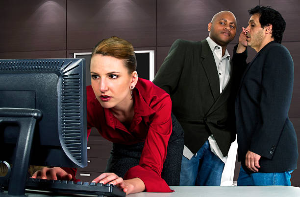 Female Worker in an Office Sexually Harassed by Businessmen stock photo