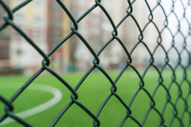 Fence netting close-up on a background of a soccer field stock photo