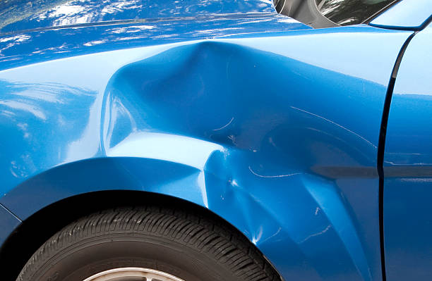 Fender Bender Auto accident leaving a huge dent in the left front quarter panel. dented stock pictures, royalty-free photos & images
