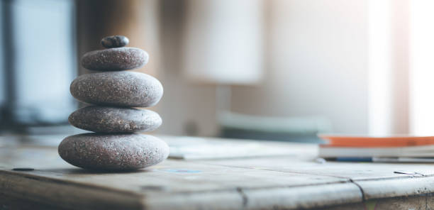Feng Shui: Stone cairn in the living room, balance and relaxation stock photo