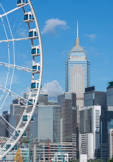 Ferris wheel and skyscraper in downtown district of Hong Kong city stock photo