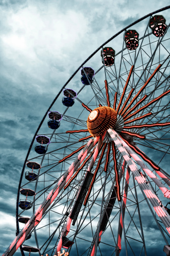 Ferris wheel and dramatic sky. Color monochrom