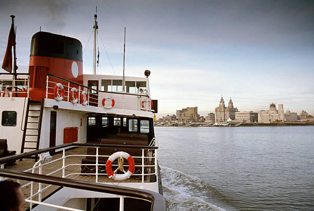 Ferry across the Mersey The Mersey Ferry and the waterfront skyline of Liverpool, England. river mersey liverpool stock pictures, royalty-free photos & images