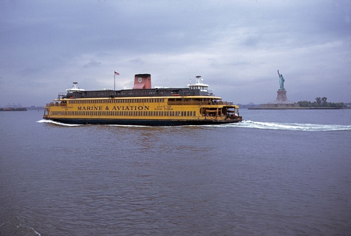 New York City, NY, USA, 1974. Ferry of the Marine & Aviation line on the way to Staten Island. Also: the Statue of Liberty.