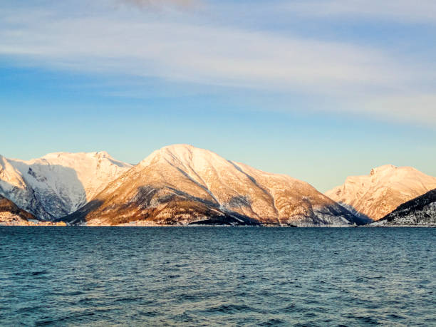Ferry from Vangsnes to Dragsvik, Balestrand. Winter landscape and fjord with sunrise sunset in Norway. stock photo