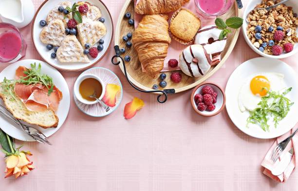 Festive brunch or breakfast set for Valentines day, Mothers day or Easter. Festive brunch or breakfast set for Valentines day, Mothers day or Easter. Pink background. Overhead view . brunch stock pictures, royalty-free photos & images