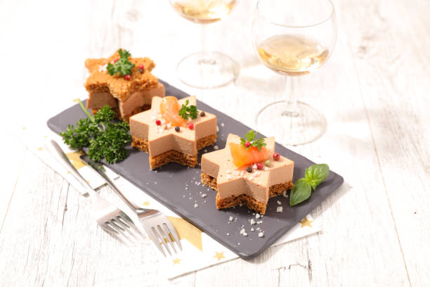 festive canape with foie gras and salmon on gingerbread toast festive canape with foie gras and salmon on gingerbread toast foie gras stock pictures, royalty-free photos & images