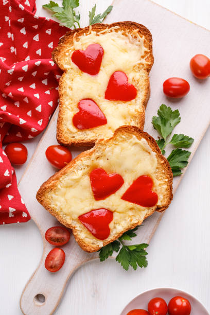 Festive cheese toast with red pepper on a white board. stock photo