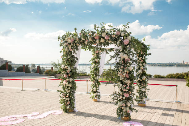 A festive chuppah decorated with fresh beautiful flowers for an outdoor wedding ceremony. A festive chuppah decorated with fresh beautiful flowers for an outdoor wedding ceremony. ketubah stock pictures, royalty-free photos & images
