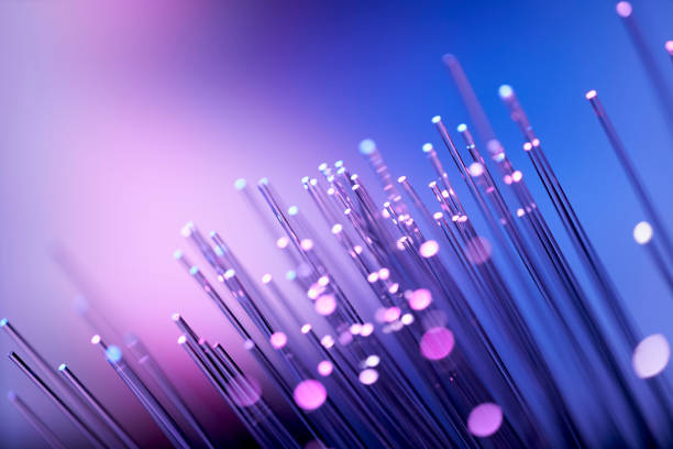 fiber optics abstract background - purple blue data internet technology cable - fibra imagens e fotografias de stock