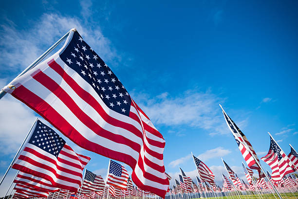 Field of American Flags A field of hundreds of American flags.  Commemorating veteran's day, memorial day or 9/11. memorial day background stock pictures, royalty-free photos & images