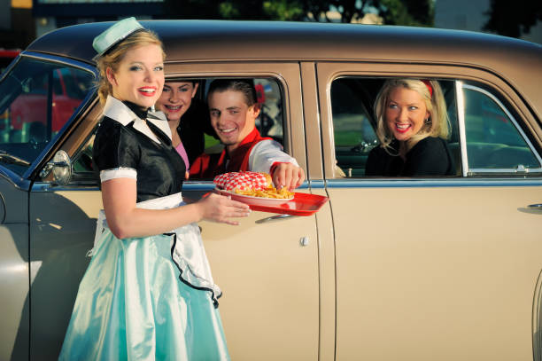 Fifties Drive In With Car Hop and Customers stock photo