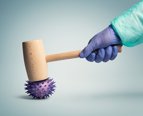 Medical worker using a hammer to destroy a flu virus