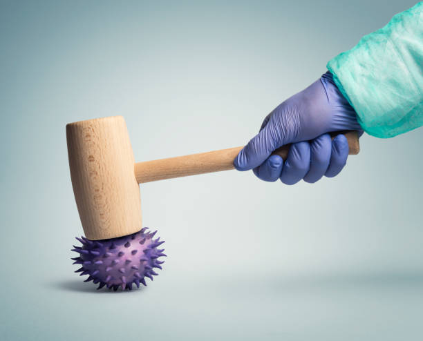 Fight against coronavirus  flu virus Medical worker using a hammer to destroy a flu virus defeat stock pictures, royalty-free photos & images