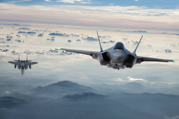 fighter jets flying at twilight - f 35 imagens e fotografias de stock