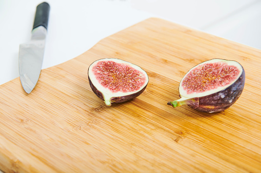 Cooking vegan food. Half figs on a kitchen counter