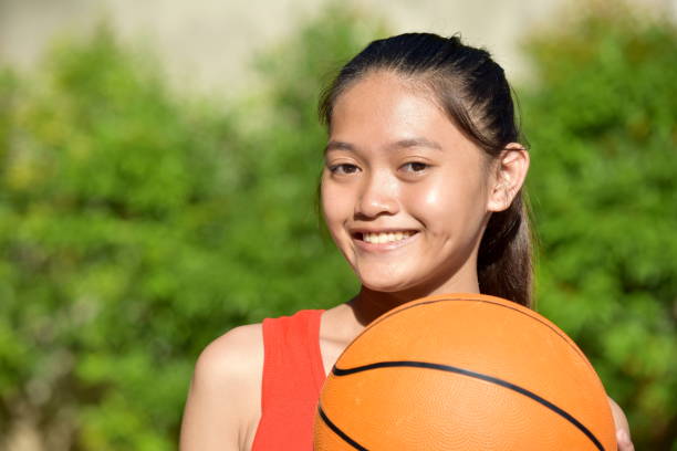 Filipina Teen Athlete Female Basketball Player Smiling With Basketball A person in an outdoor setting philippine girl stock pictures, royalty-free photos & images
