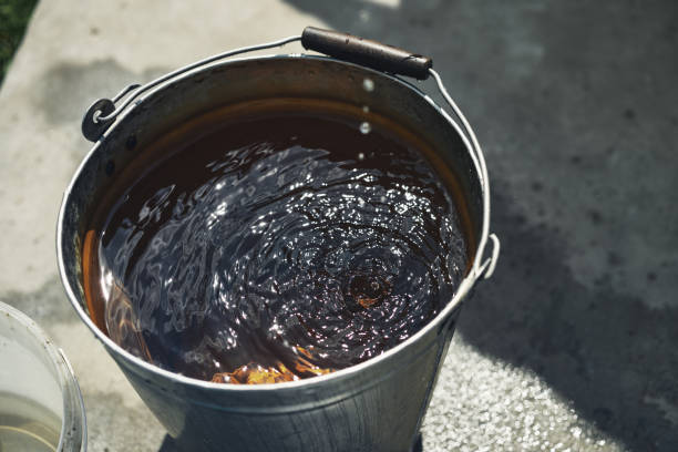 Filled iron bucket of clean water from a well. stock photo