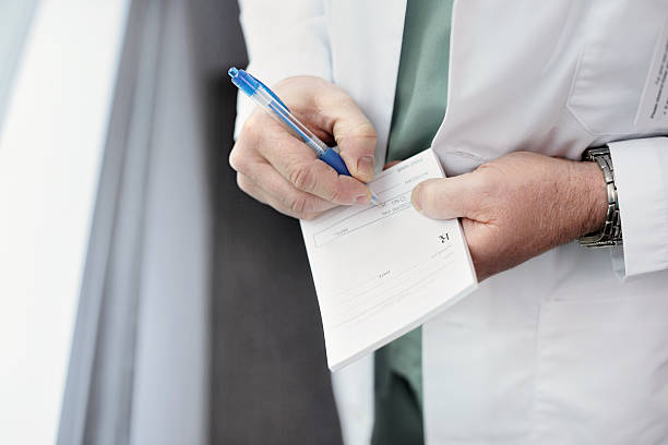Filling out a doctor's prescription stock photo