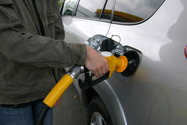 Filling Up with Fuel Filling Up with gas or petrol at the bowser bowser stock pictures, royalty-free photos & images