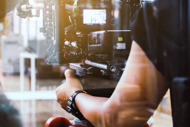 Film crew filming production. cameraman shooting film scene with camera manufacturing photos stock pictures, royalty-free photos & images