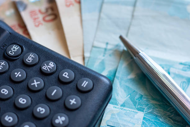 Finance Concept - Calculator, Brazilian Money and Pen stock photo