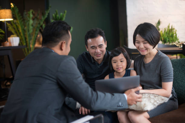 Financial advisor with clients. Asian family listening to a presentation by a financial advisor. business Malaysia stock pictures, royalty-free photos & images