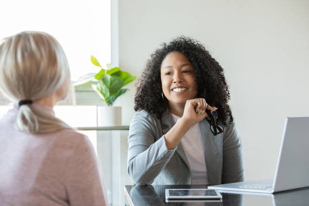 Financial Aid Consultant meeting with Young Woman stock photo