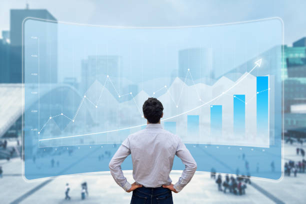 Financial data showing growing revenue and successful business strategy. Finance analyst or executive manager analyzing profit on chart report with city background. stock photo