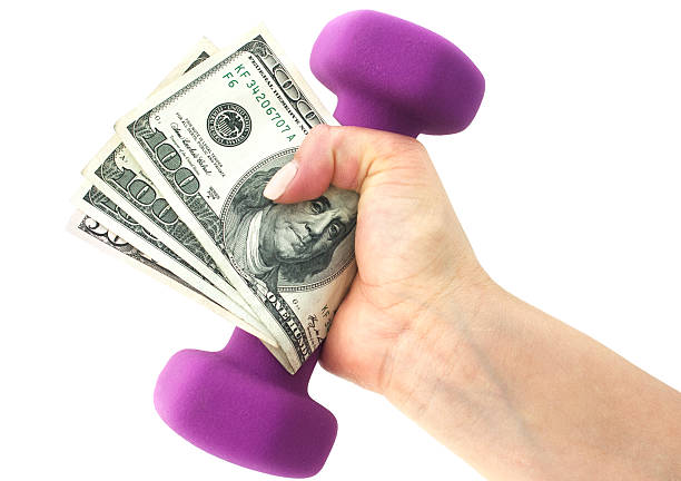 Hand with a dumbbell and cash on a white background.