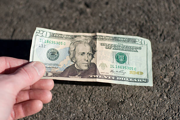 Find a 20$ bill on the street stock photo