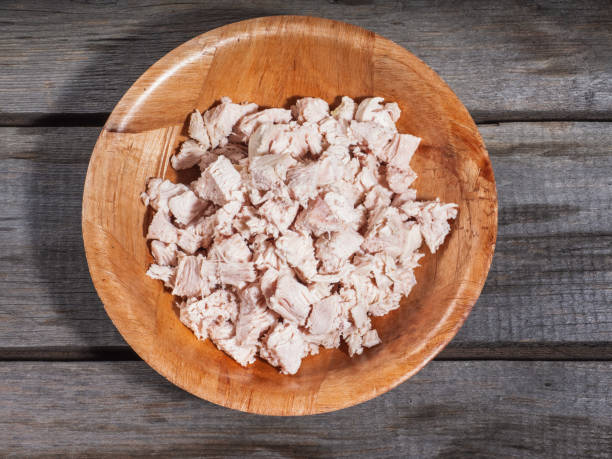 Finely chopped boiled chicken in a bamboo plate Chopped boiled chicken in a bamboo plate on an old rustic table boiled stock pictures, royalty-free photos & images