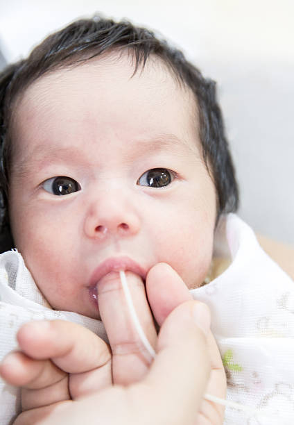 Finger Feeding baby stock photo