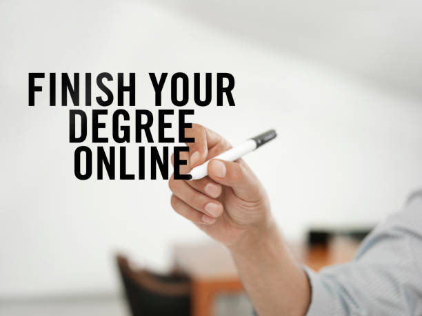 Finish your degree Businessman writing “Finish your degree online” on a virtual screen online degrees stock pictures, royalty-free photos & images